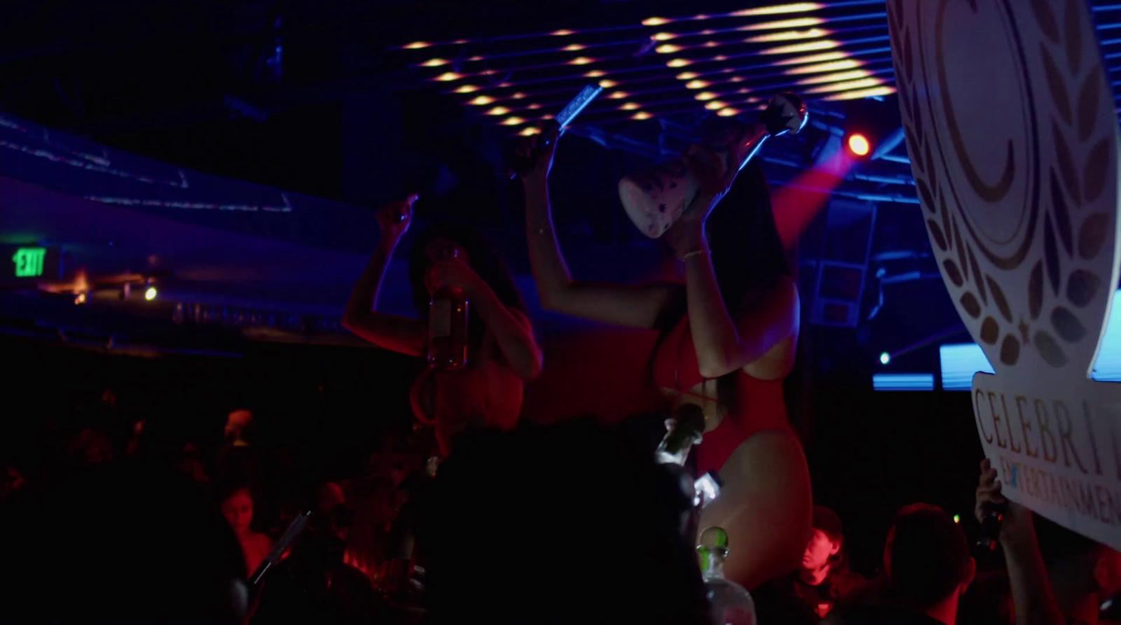 a woman in a red swimsuit standing on a stage