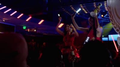 a couple of women standing on top of a dance floor