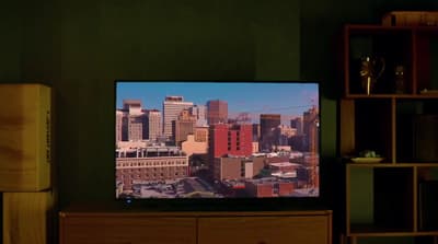 a flat screen tv sitting on top of a wooden dresser