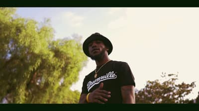 a man wearing a hat and a black shirt