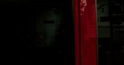 a red stop sign sitting on the side of a building