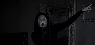 a person with a microphone in a dark room