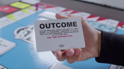 a hand holding a card that says, out come