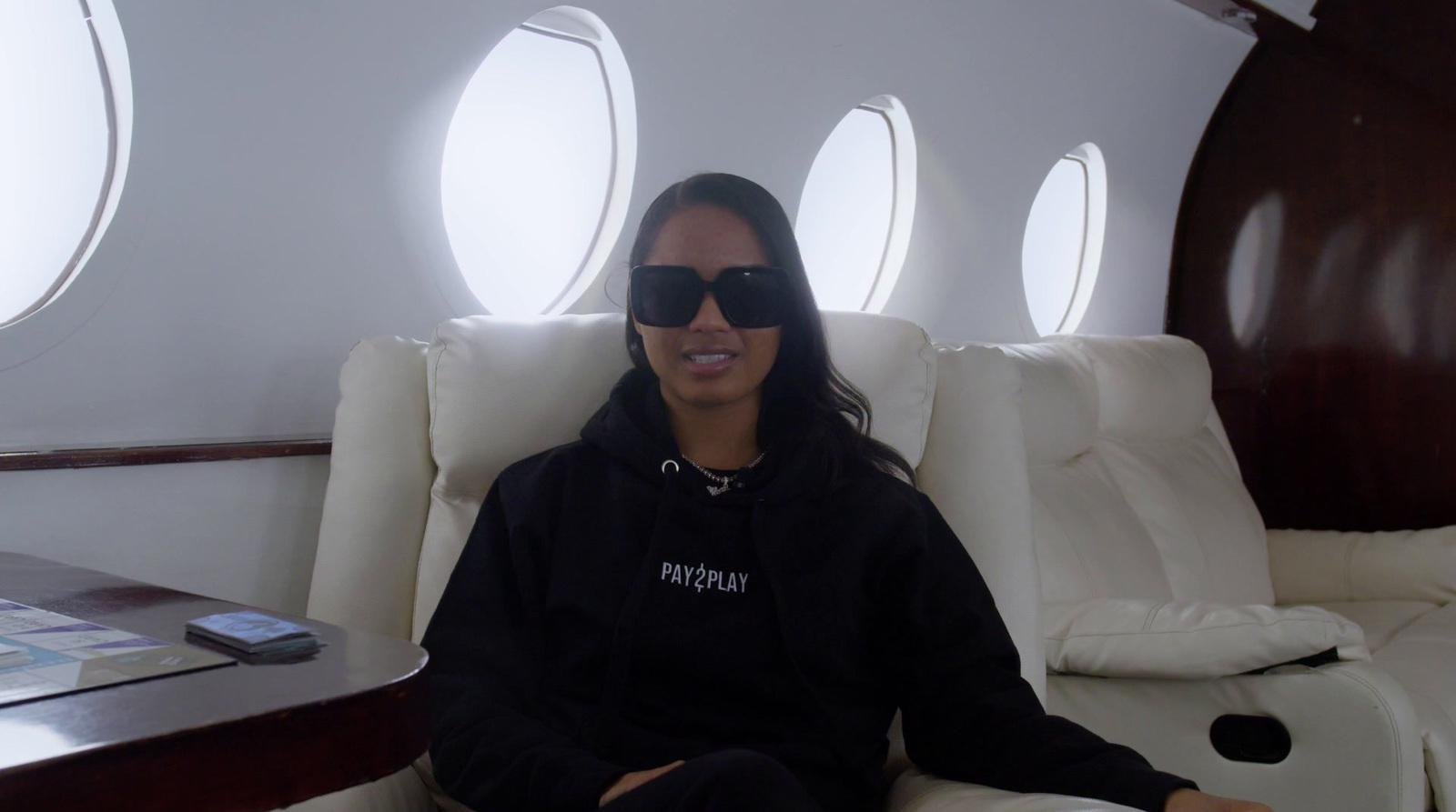 a woman wearing sunglasses sitting in a chair