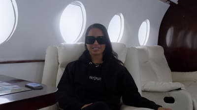 a woman wearing sunglasses sitting in a chair