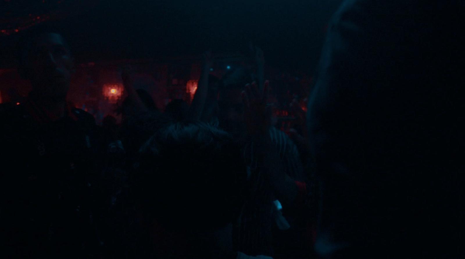 a crowd of people in a dark room