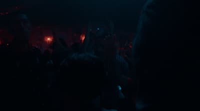 a crowd of people in a dark room