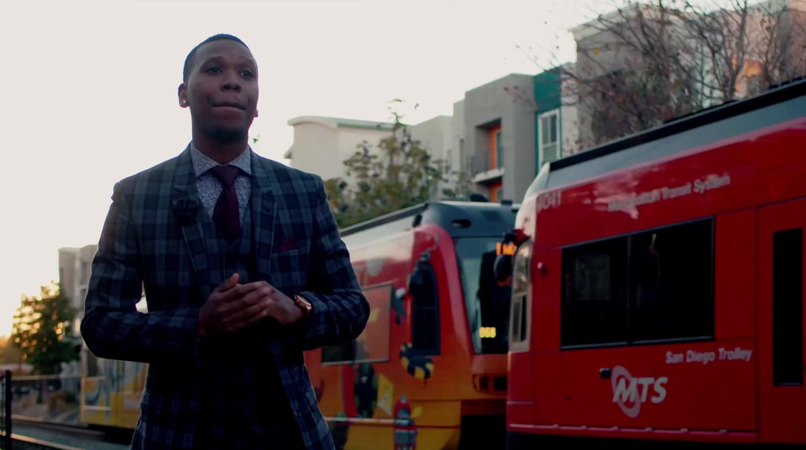 a man standing in front of a red train