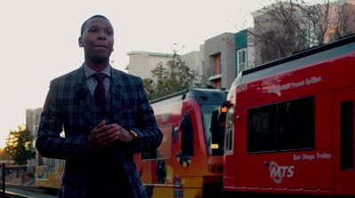 a man standing in front of a red train