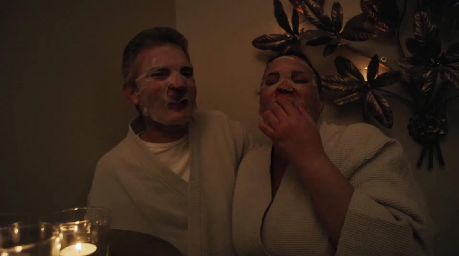 a man and a woman with their faces covered in frosting