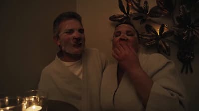 a man and a woman with their faces covered in frosting