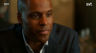 a man in a suit is looking at something