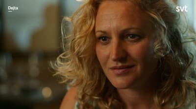 a woman with blonde hair is staring into the camera