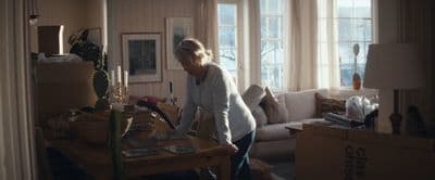 a woman is standing in a room with boxes