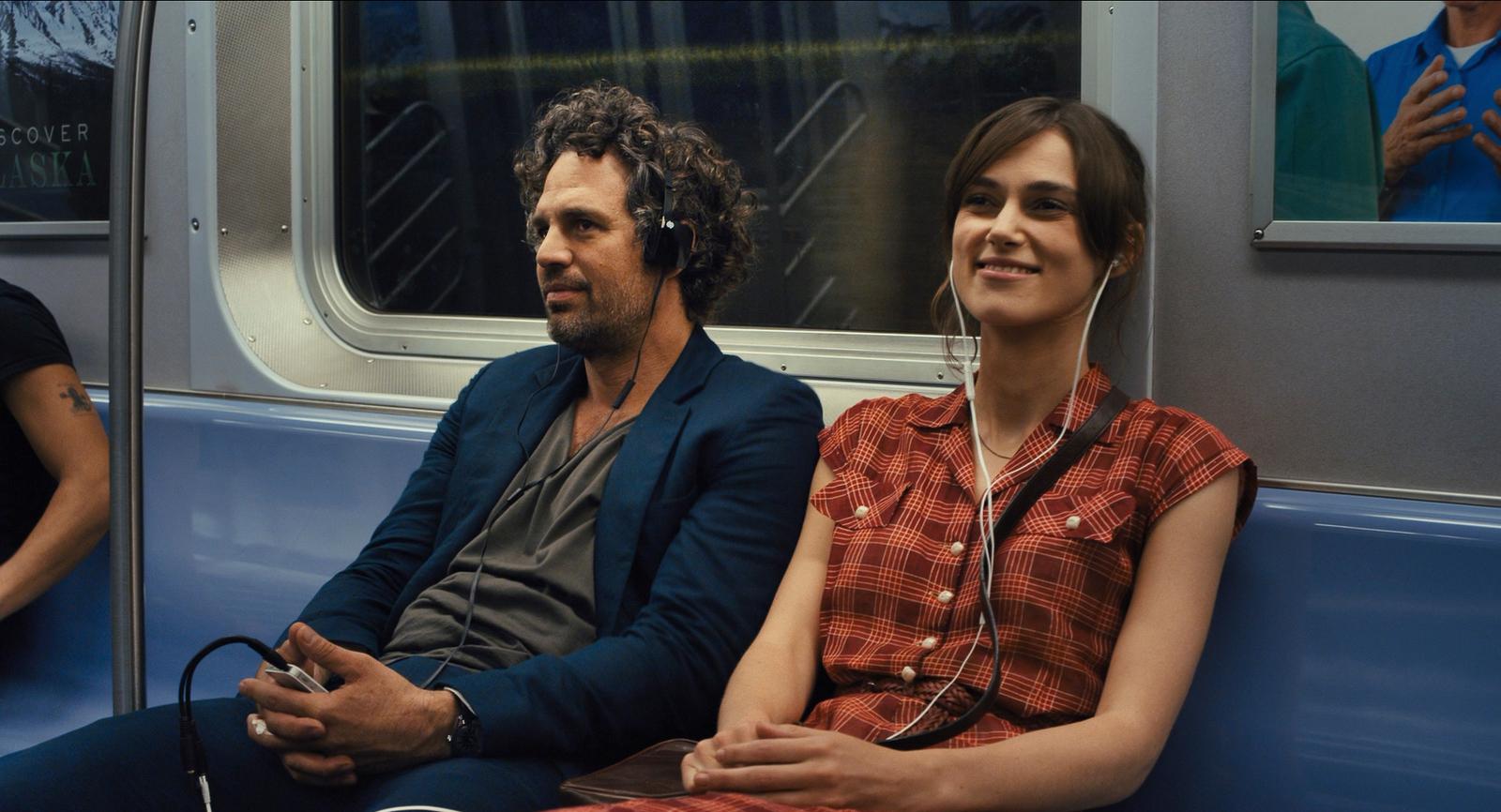 a man and a woman sitting on a train