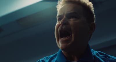a man in a blue shirt with his mouth open