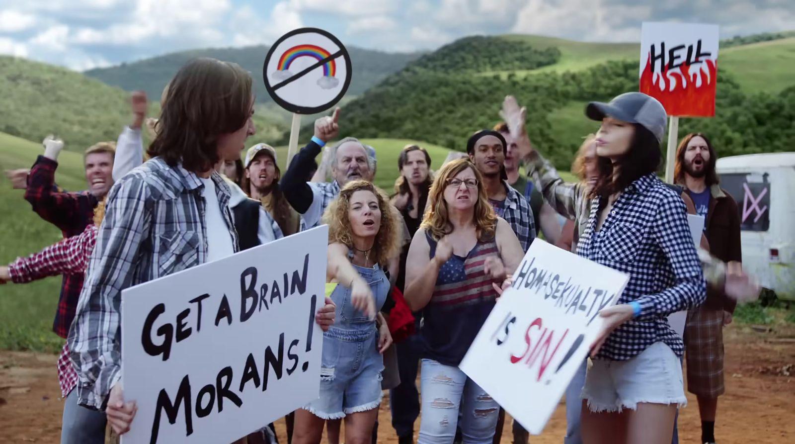 a group of people holding signs in the dirt