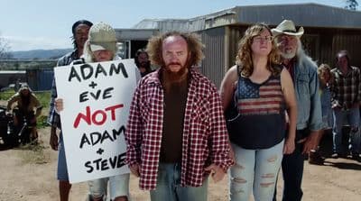a group of people holding a sign that says adam and eve not adam steve