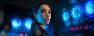 a woman in a black leather jacket looking at the camera