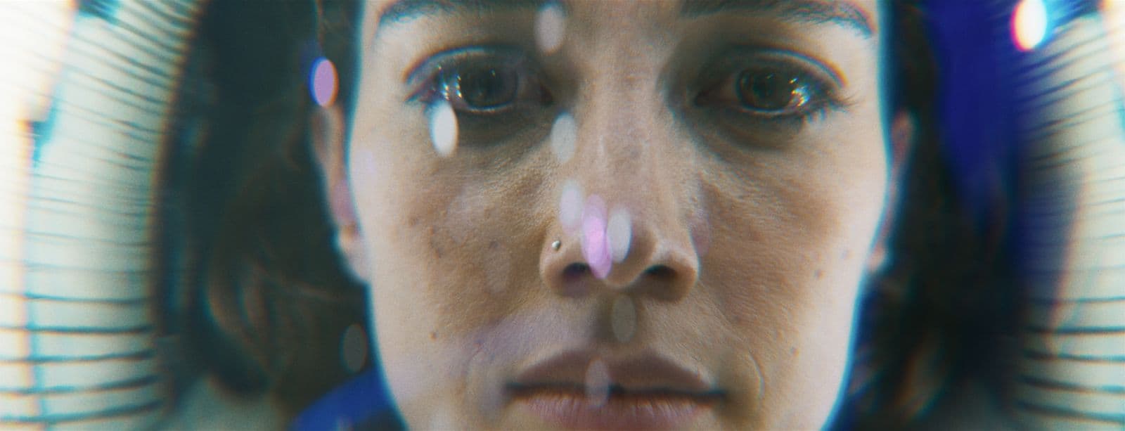 a close up of a woman's nose and nose piercing