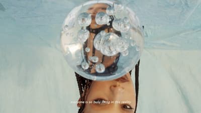 a woman with a bubble ball on her head
