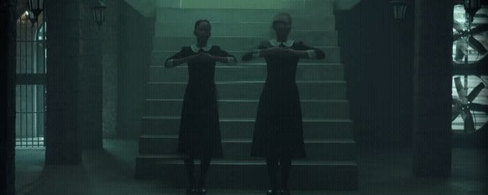 a couple of women standing on top of a set of stairs