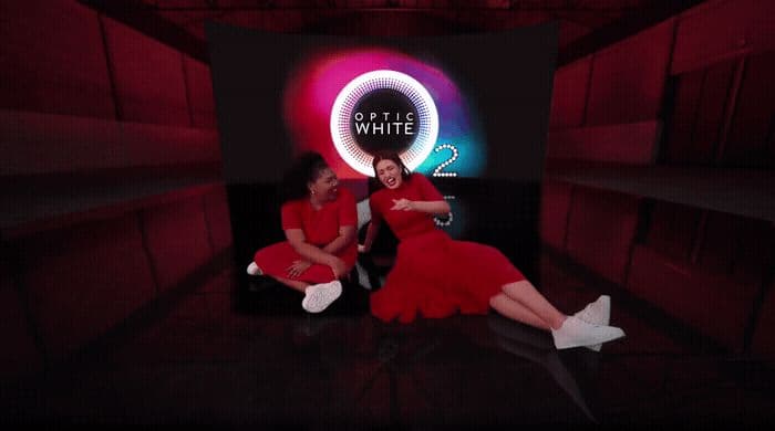 a couple of women sitting on top of a black table