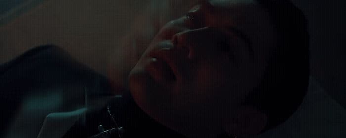 a man laying down with his eyes closed