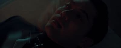 a man laying down with his eyes closed