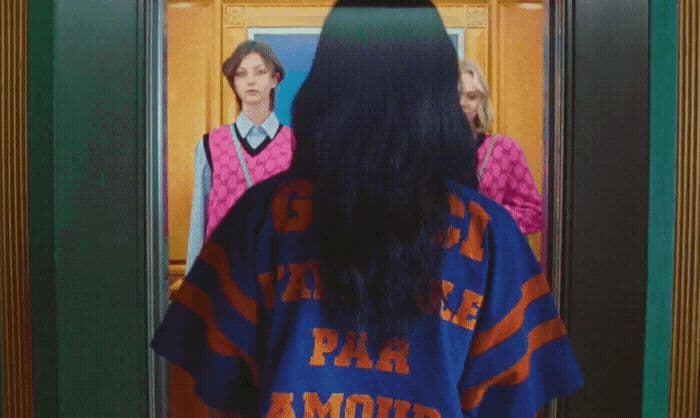 a woman standing in front of a mirror
