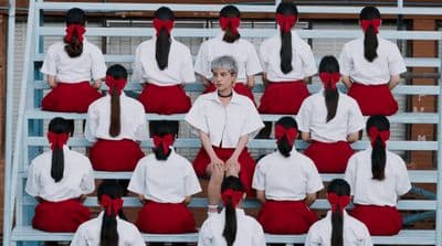 a group of women sitting on top of a bleachers