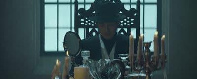 a person sitting at a table with candles