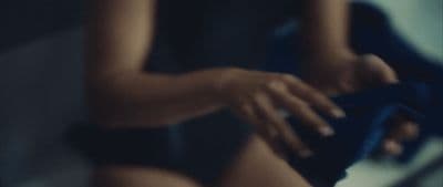a close up of a woman's legs with a blue ribbon