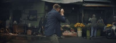 a man is taking a picture of himself in the street