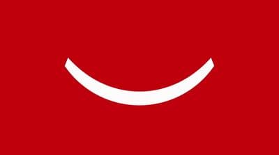 a red background with a white smiley face