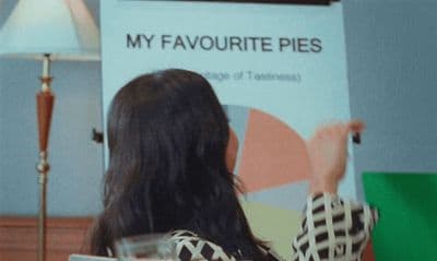 a woman standing in front of a sign in a room