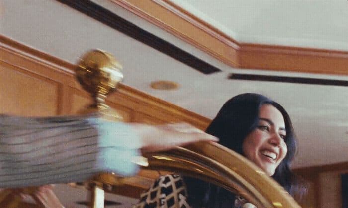 a woman is holding a golden instrument in her hand