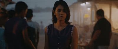 a woman standing in front of a group of people