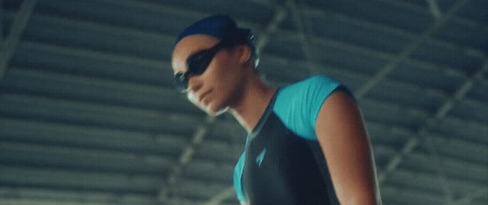 a woman wearing sunglasses and a blue shirt