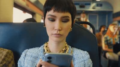a woman on a train looking at her cell phone