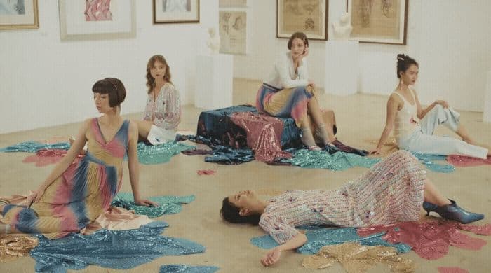 a group of people sitting on the ground in a room