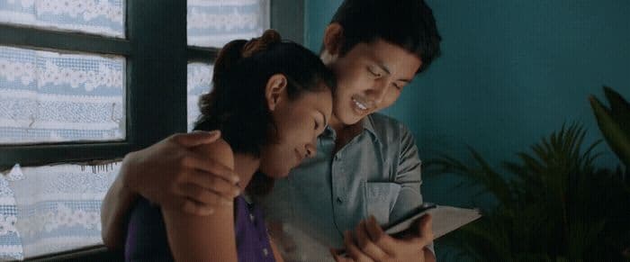 a man and a woman looking at a cell phone