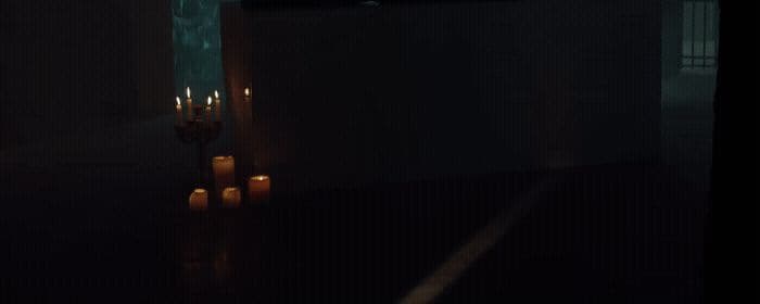 candles are lit in a dark room in the dark
