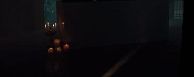 candles are lit in a dark room in the dark