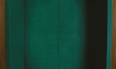 a room with a green wall and a wooden door