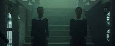 a couple of women standing next to each other in a hallway