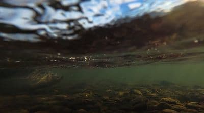 an underwater view of rocks and water
