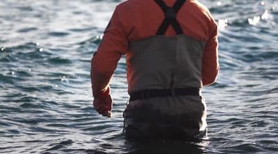 a man standing in a body of water