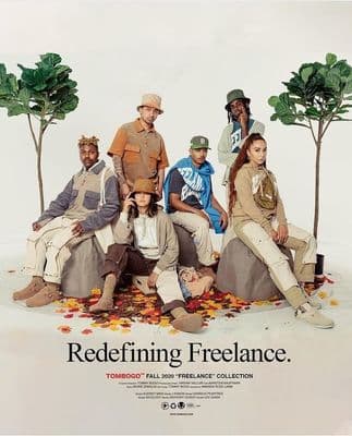 a group of people sitting on top of a pile of leaves