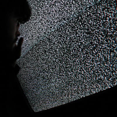 a man standing in front of a television screen